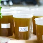 Homemade chicken stock in containers