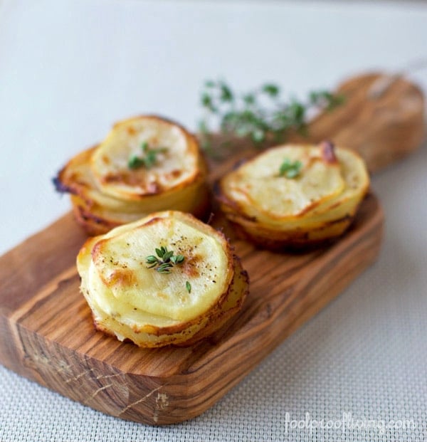 Potatoes cooked in muffin tin placed on a cutting board