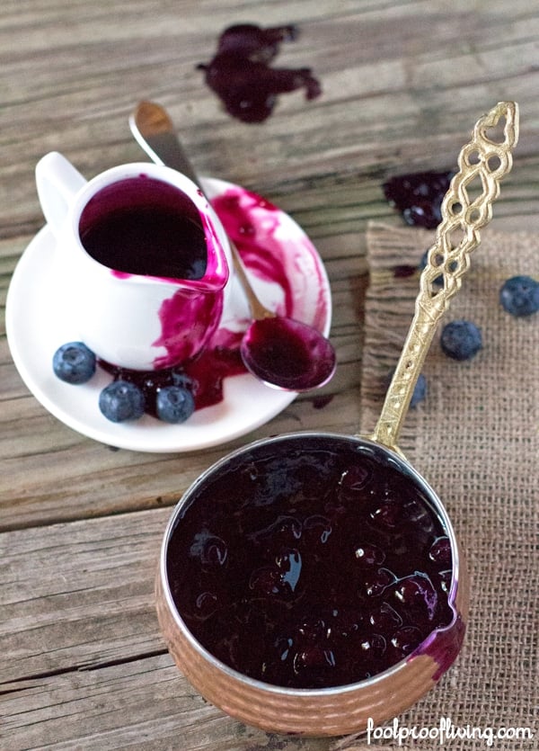 The Best Blueberry Sauce For Pancakes placed in a small pour cup
