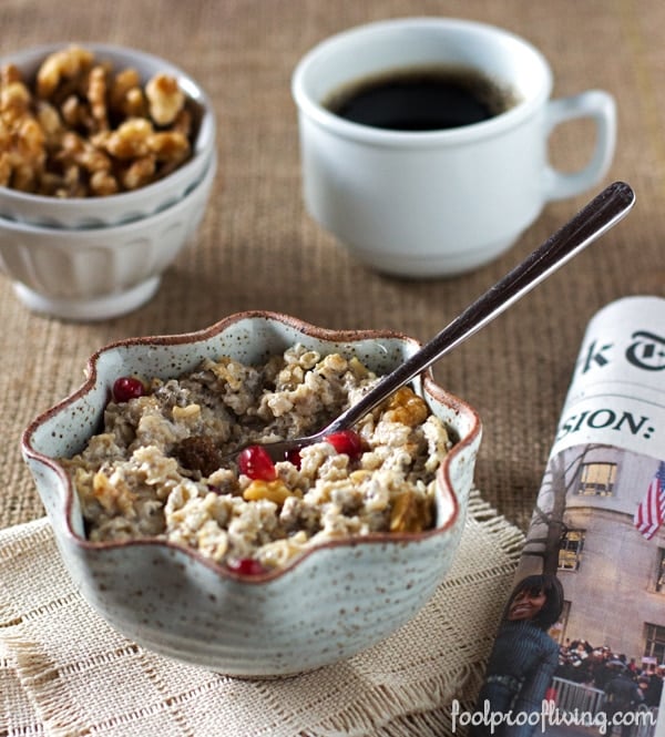 A bowl of Almond Milk Oatmeal with Chia Seeds served with a spoon and a newspaper on the side for breakfast