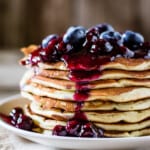 Lemon Ricotta Pancakes stacked and topped off with blueberry drizzle