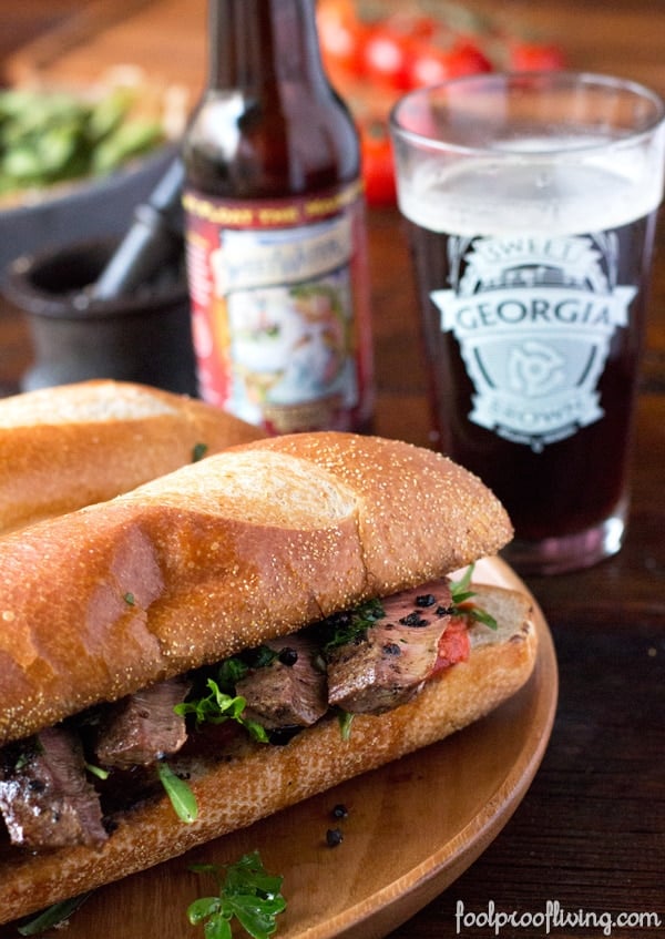 Chimichurri Steak Sandwich with a glass and a bottle of beer