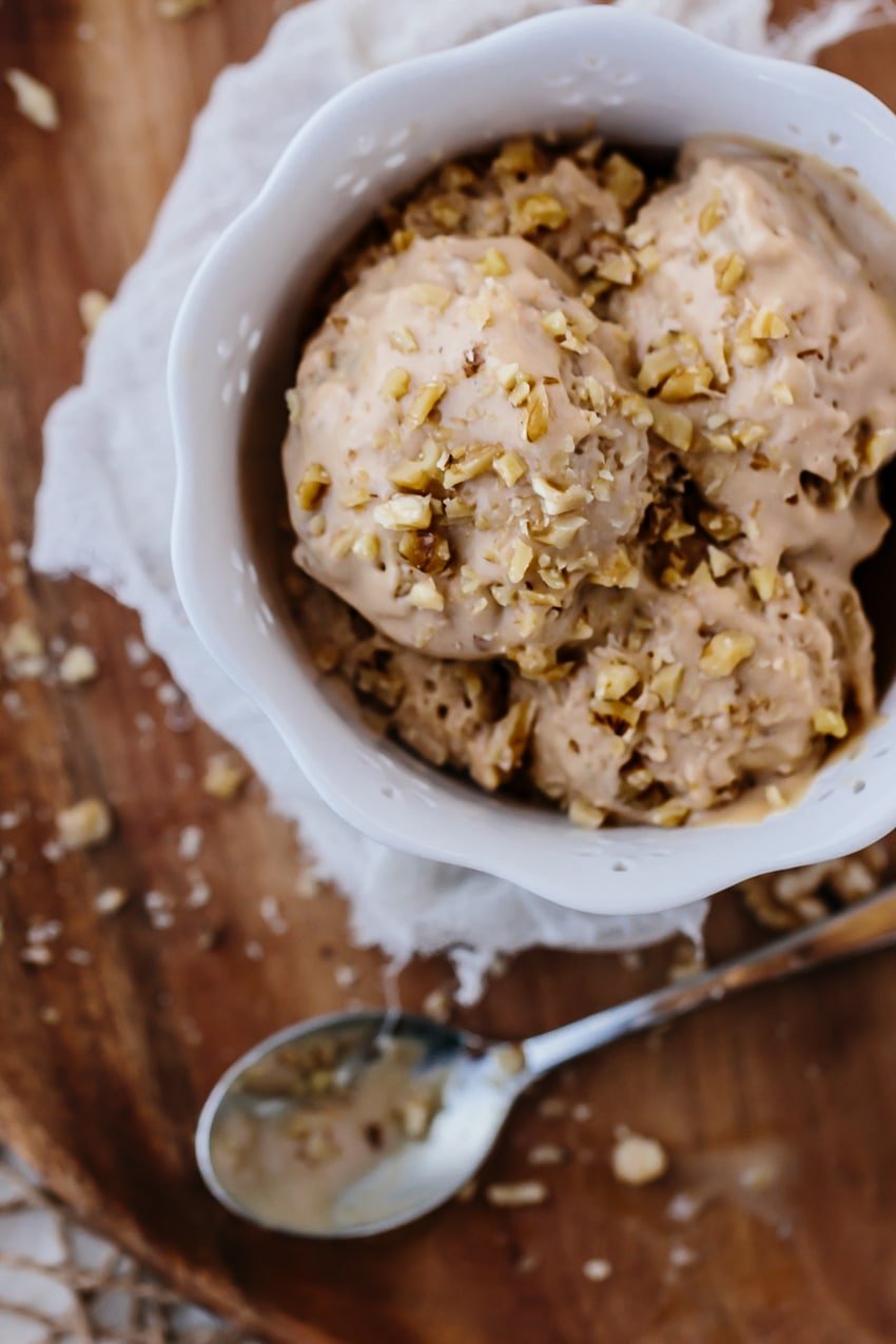 A bowl filled with Biscoff Walnut Ice Cream garnished with walnuts