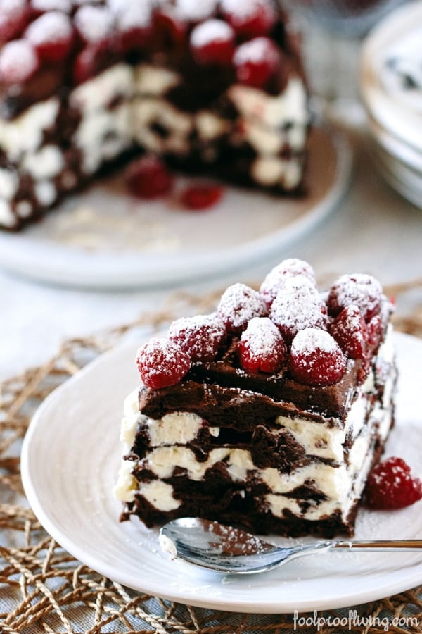 Sliced Dark Chocolate Waffle Cake with Mascarpone Whipped Cream and a single serving on another plate