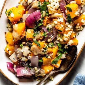 Butternut Squash Salad with bulgur wheat in a plate with a spoon on the side