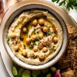 Authentic hummus in a bowl drizzled with olive oil.
