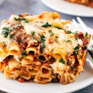 baked ziti with meat sauce sliced and placed on a plate