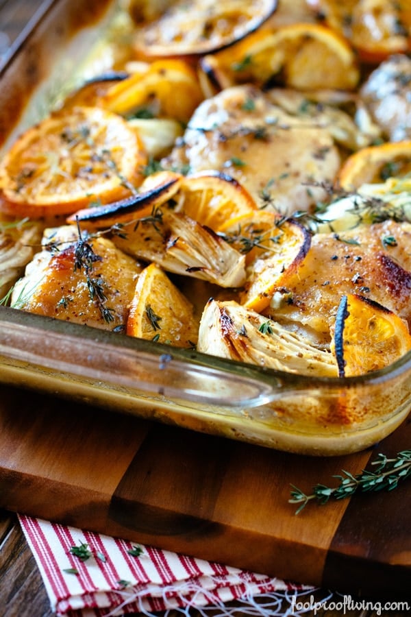 Freshly baked chicken with charred blood oranges is photographed from the front view