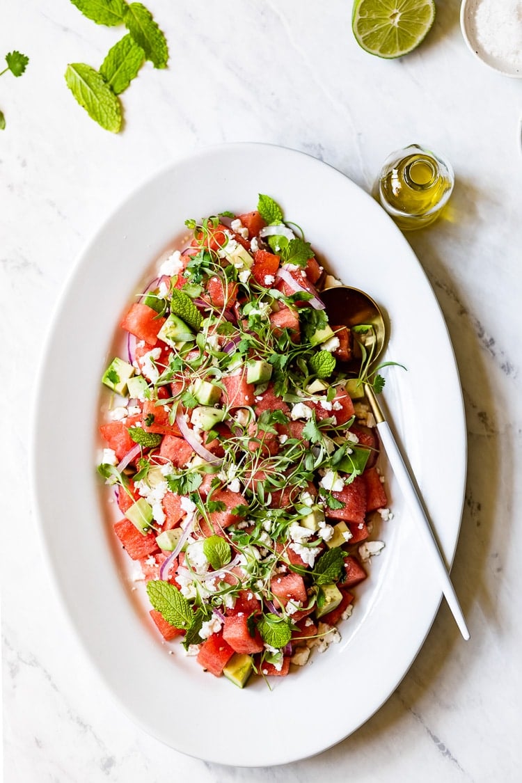 A plate of Watermelon Avocado Salad with olive oil on the side