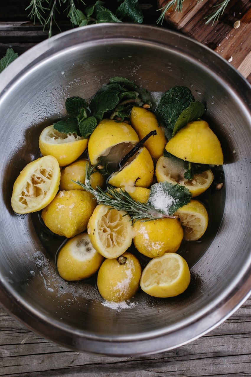 mint, vanilla, lemon, rosemary topped off with sugar in a bowl photographed from the top view.