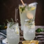 Mint and Rosemary Lemonade with Vanilla in mason jars garnished with rosemary sprigs