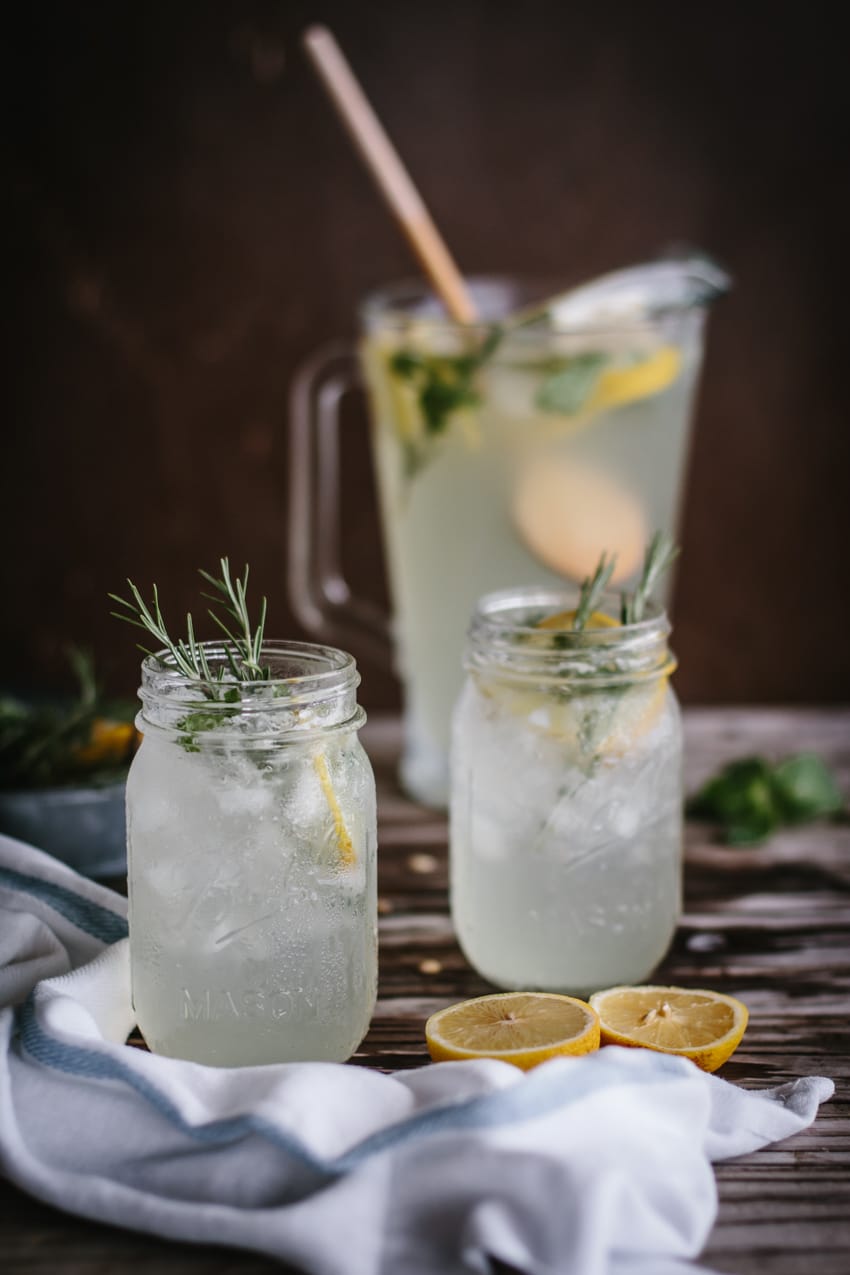 Mint and Rosemary Lemonade with Vanilla in mason jars garnished with rosemary sprigs