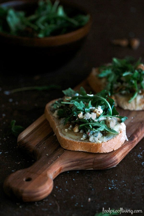 Close up view of 2 slices Gorgonzola-Walnut Bruschetta with Truffle Oil on a cutting board