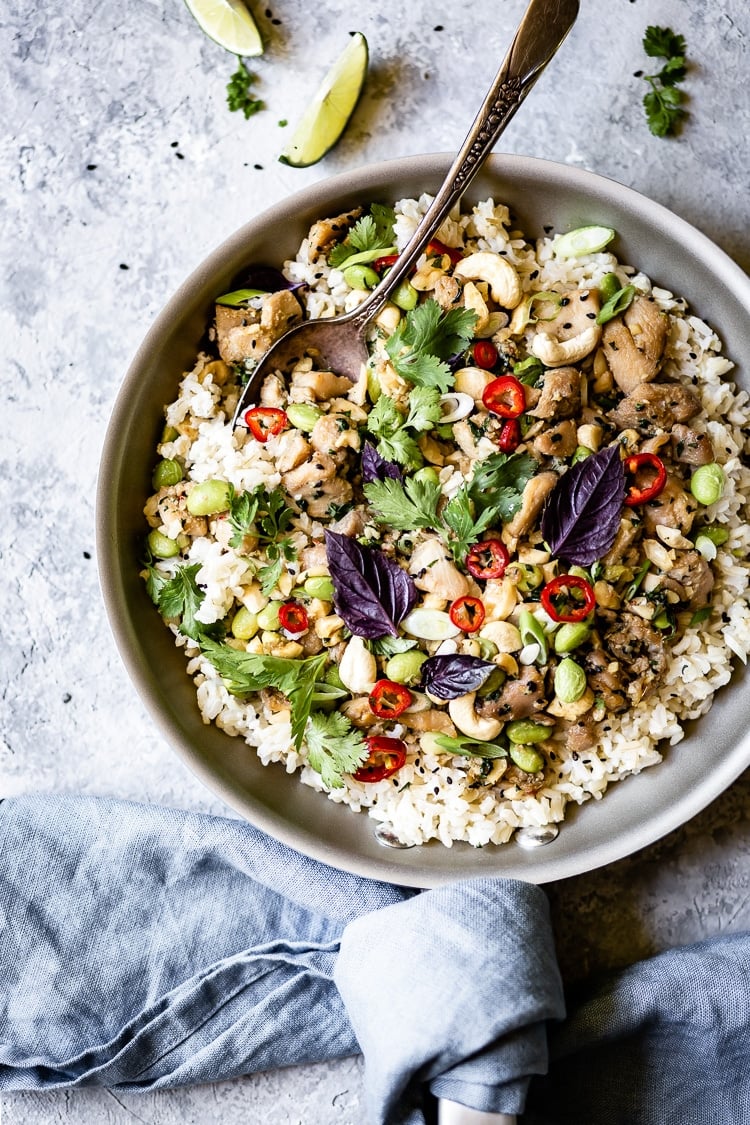 A skillet with Thai Lemongrass Chicken with a spoon on the side