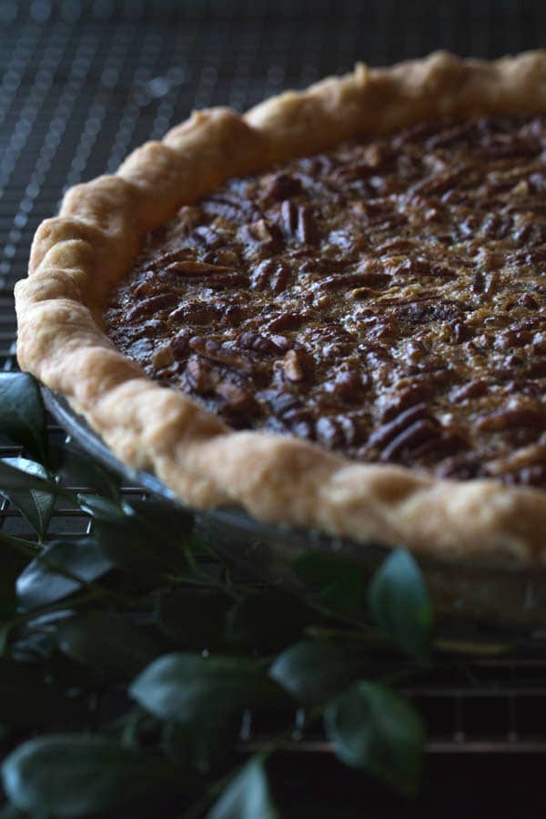 Close up frontal view of an Old-Fashioned Maple Pecan Pie with Bourbon Whipped Cream