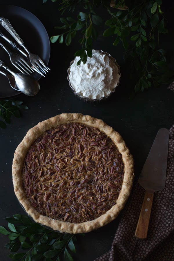 Old-Fashioned Maple Pecan Pie with Bourbon Whipped Cream and flatware