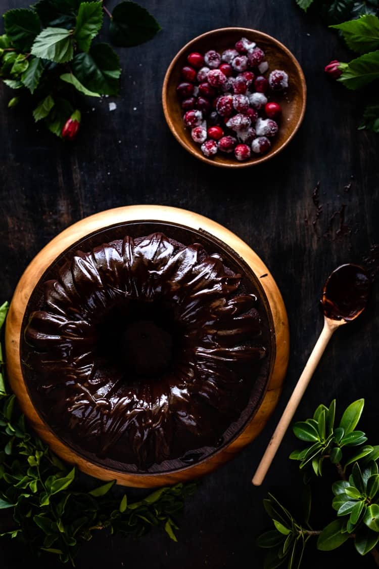 sour cream chocolate cake with sugared cranberries on the side