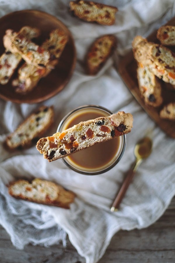 A slice of Caribbean Biscotti resting over a cup of coffee