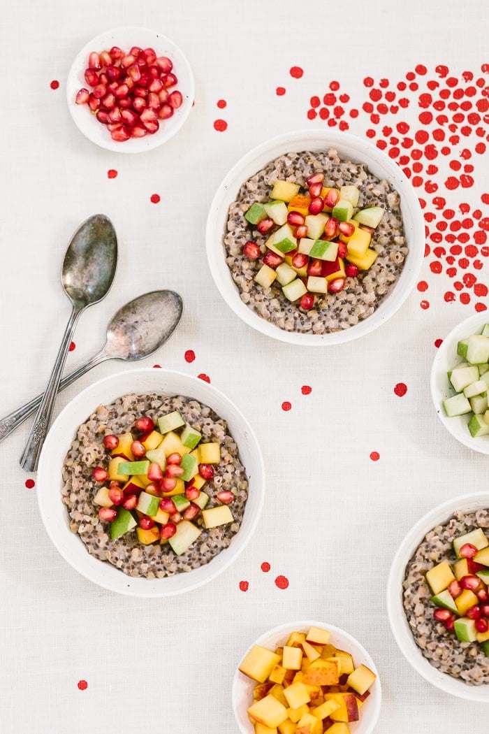 A few bowls of Overnight Coconut Buckwheat Porridge Recipe topped off with pomegranate seeds.