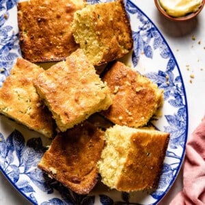 Jalapeno cornbread cut into squares placed on a plate.