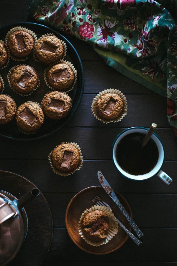 Several Banana Muffins with Toblerone Chunks with a cup of coffee