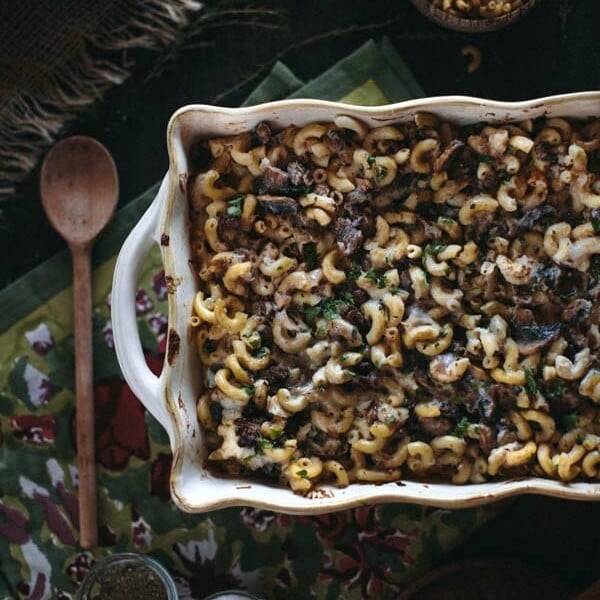 Oxtail Macaroni Gratin in a casserole dish with a wooden spoon on the side