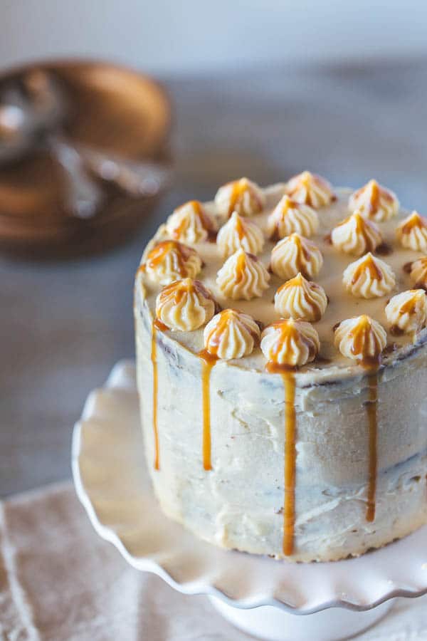 A 6-inch banana cake on a cake stand from the front view.