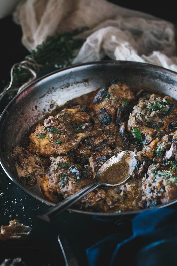 Close up view Chicken Thighs in a pan with spoon