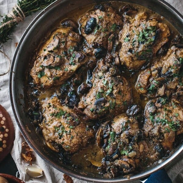 Braised Chicken Thighs with Mushrooms and Almond Purée in a pan
