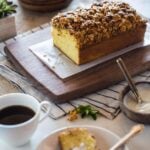Sliced Orange Polenta Cake with Almond and Oat Streusel with a cup of coffee