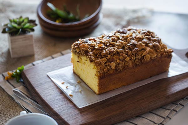 Sliced Orange Polenta Cake with Almond and Oat Streusel on a cutting board