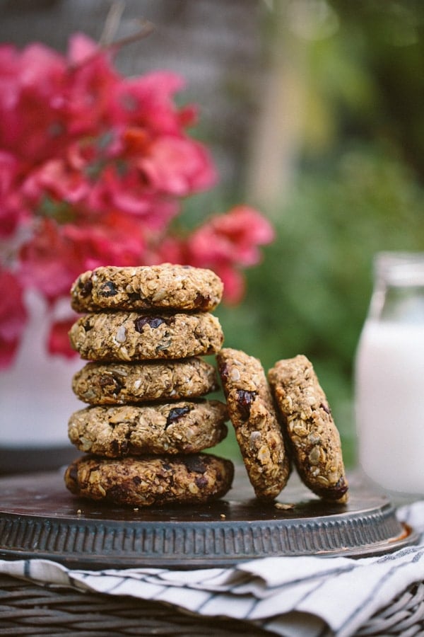 Healthy loaded breakfast bars placed on top of each other and photographed with a milk bottle in the background