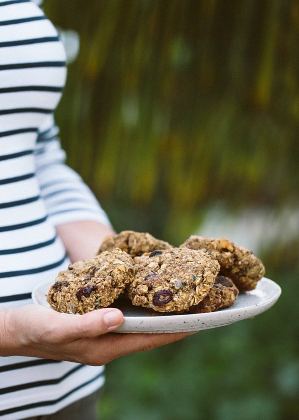 a woman is holding a plate full of fully loaded snack bars in her hand