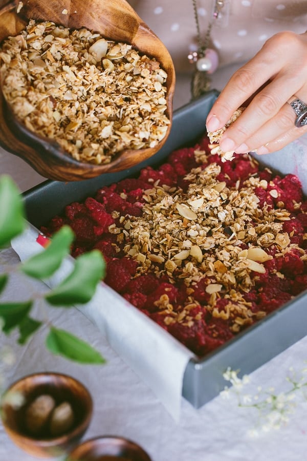 Chopped Almonds being pour raspberry mixture for breakfast bar