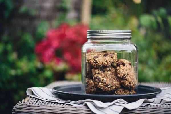 A jar of vegan and gluten free breakfast bars photographed outdoors