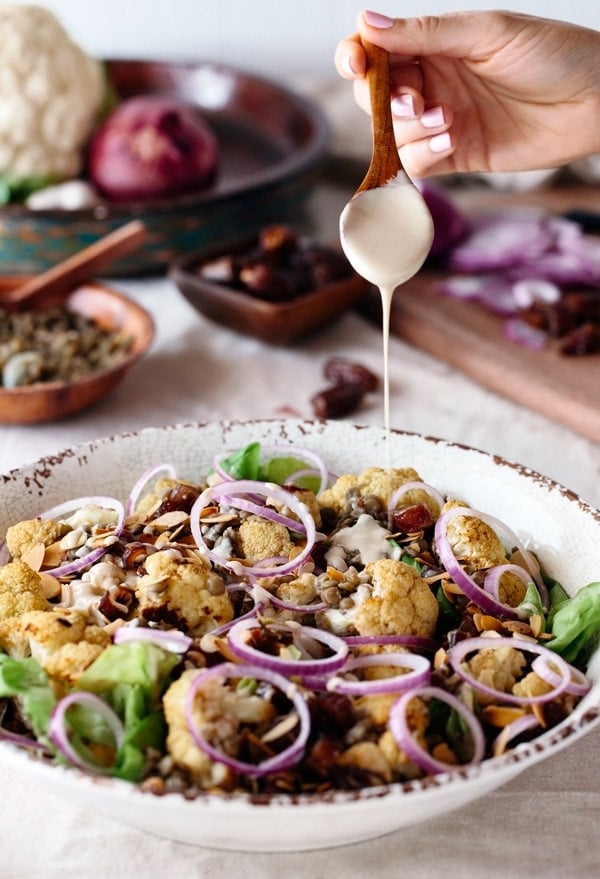 Roasted Cauliflower Salad with Lentils, Dates, and Tahini Roasted Cauliflower Salad with Lentils, Dates with Tahini Dressing in a bowl