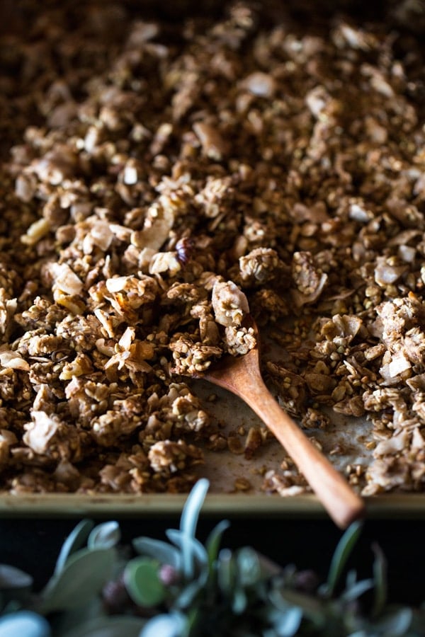 Close up of Chunky Banana Bread Granola with Chocolate Almond Milk with a wooden spoon