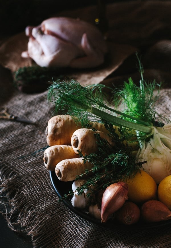 Parsnips and fennel in a bowl with a raw chicken in the background