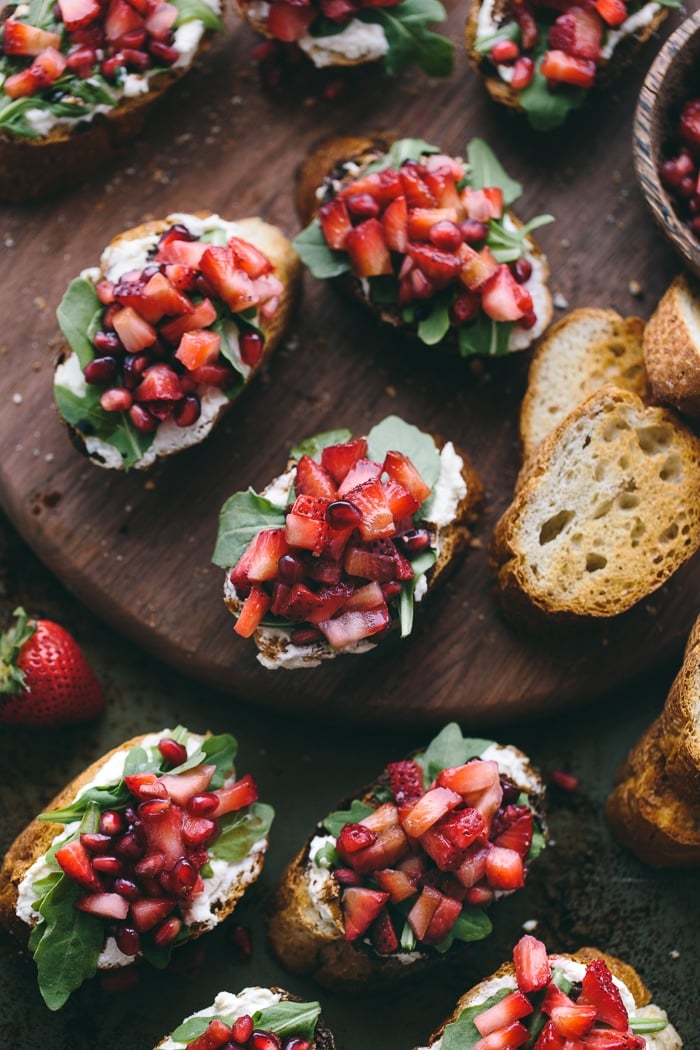 Strawberry-Ricotta Bruschetta with Balsamic Reduction: French Baguette slices spread with ricotta cheese, topped off with strawberries, and drizzled with homemade balsamic reduction.