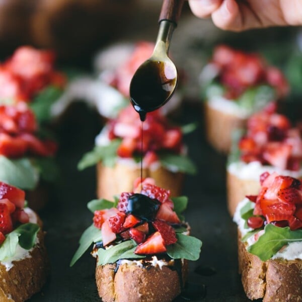 Strawberry-Ricotta Bruschetta with Balsamic Reduction: French Baguette slices spread with ricotta cheese, topped off with strawberries, and drizzled with homemade balsamic reduction.
