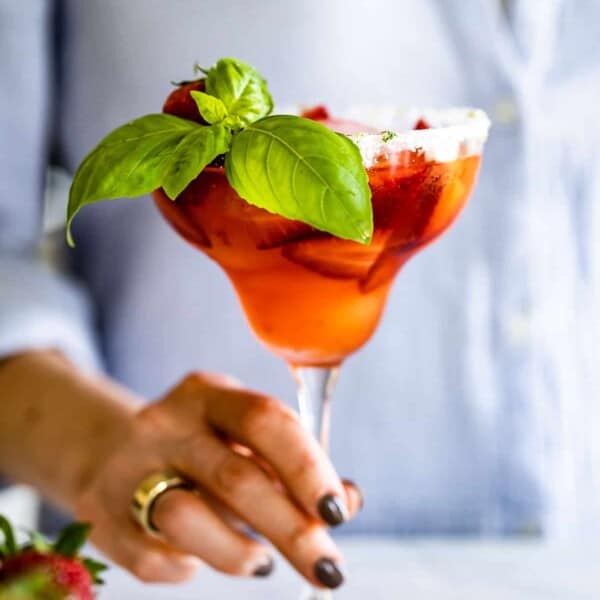 Strawberry Basil Margarita being served by a woman