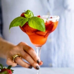 Strawberry and Basil Tequila Drink served by a woman