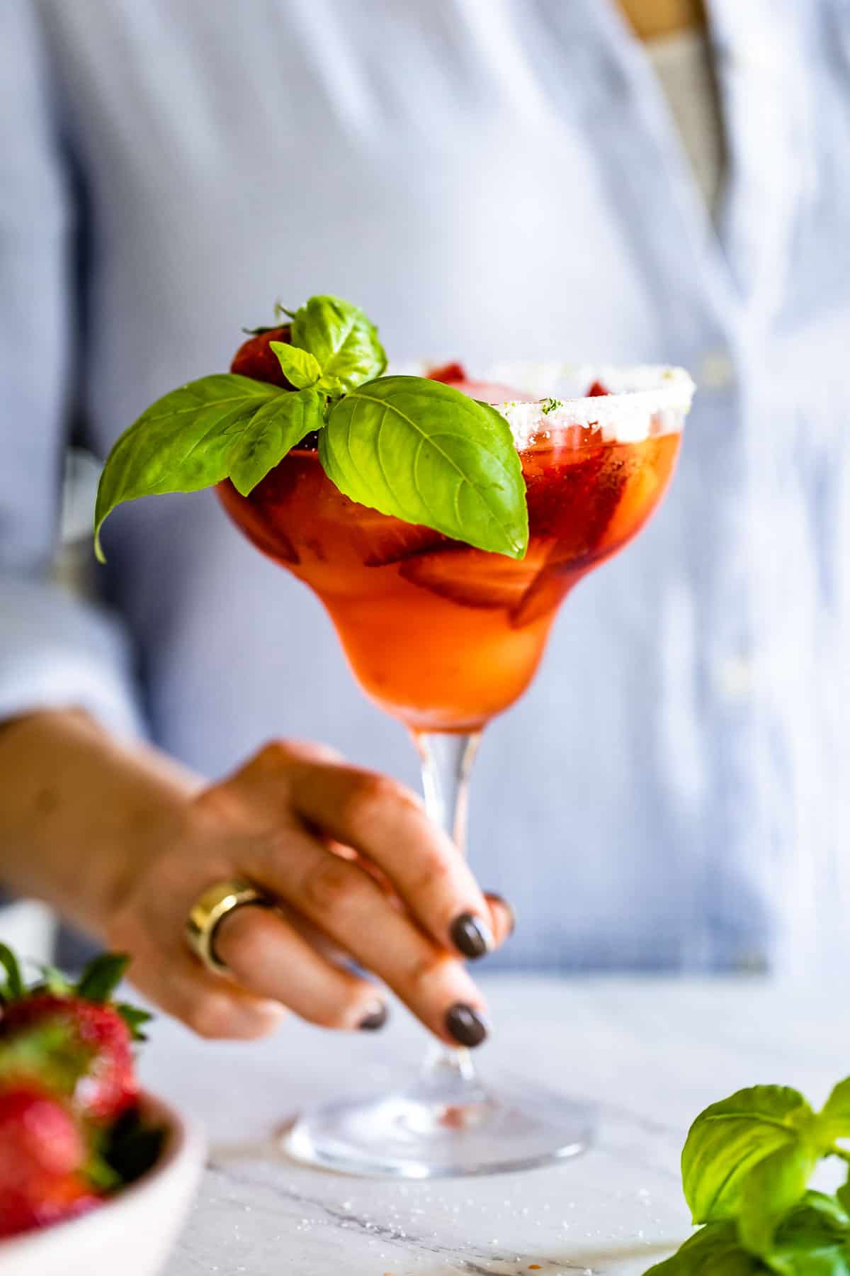 Strawberry Basil Margarita being served by a woman