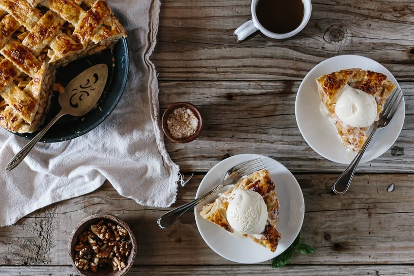 Sliced Caramel Apple Pie with two slices of apple pie and ice cream on top with a cup of coffee