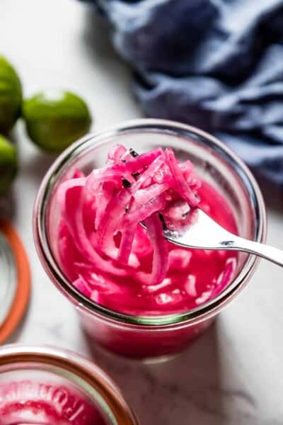 Mexican pickled onions in a jar with a fork from top view