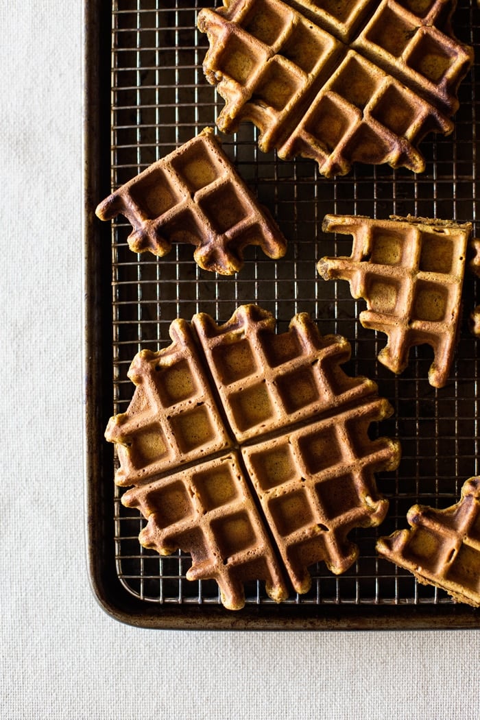 Spicy Pumpkin Waffles with Coconut Whipped Cream on a baking rack