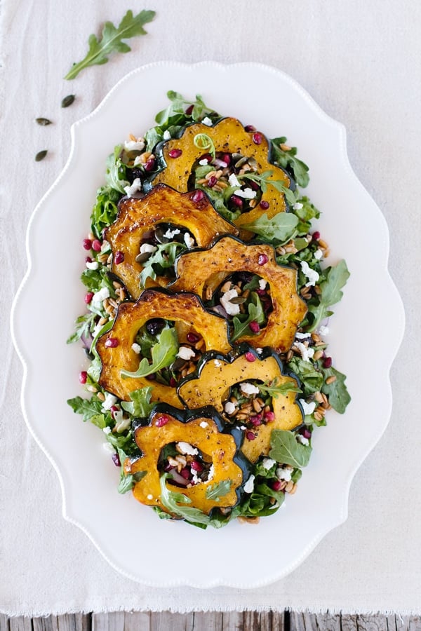 Roasted Acorn Squash Salad with Pepitas + Cranberries: A delicious and easy to make fall salad made with roasted acorn, spicy pepitas, goat cheese and cranberries.