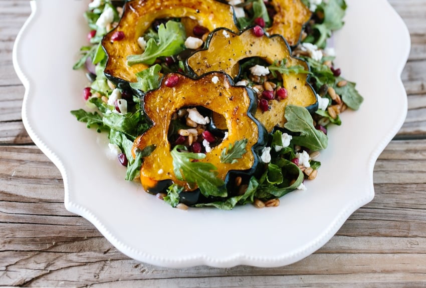 Roasted Acorn Squash Salad with Pepitas + Cranberries: A delicious and easy to make fall salad made with roasted acorn, spicy pepitas, goat cheese and cranberries.