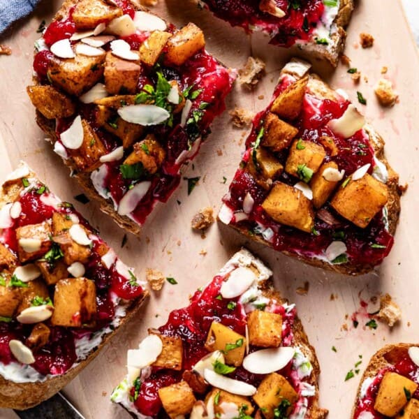 Butternut squash bruschetta garnished with nuts from the top view.