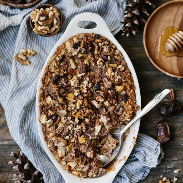 A delicious and easy-to-make autumn baked oatmeal breakfast with date butter, apples, and walnuts.